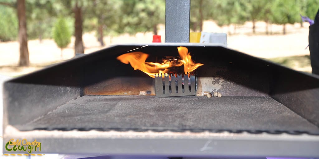 Flame inside the outdoor pizza oven as it heats up