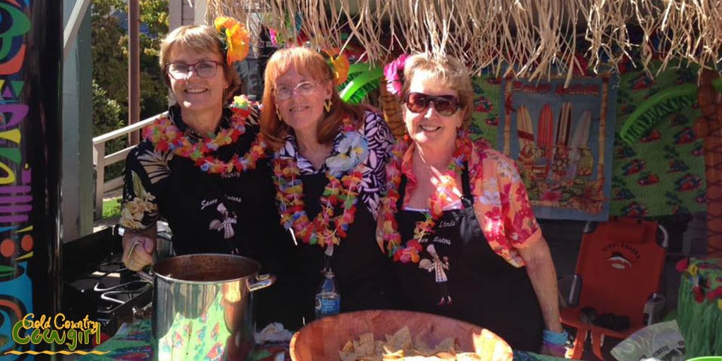 Three Saucy Sisters take a quick break from serving chili and salsa