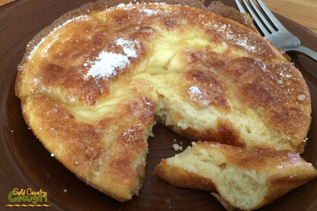 Sourdough Dutch baby pancake with a wedge cut out