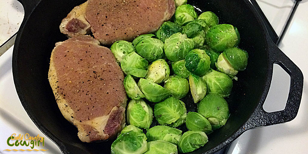 Brussels sprouts added to skillet with pork chops