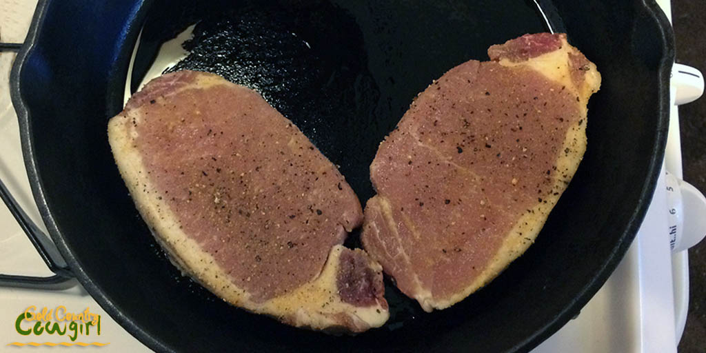 Pork chops on one side of skillet