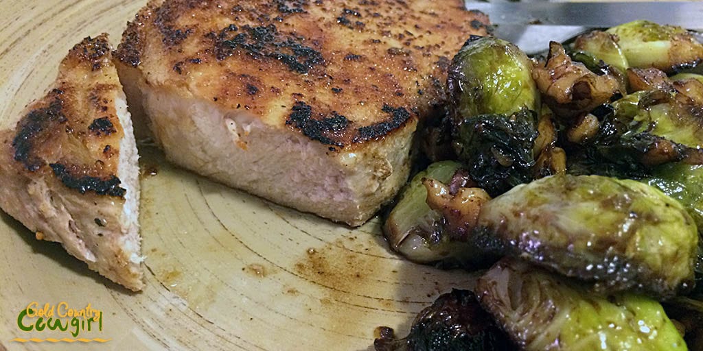 Served pork chop and Brussels sprouts with walnuts