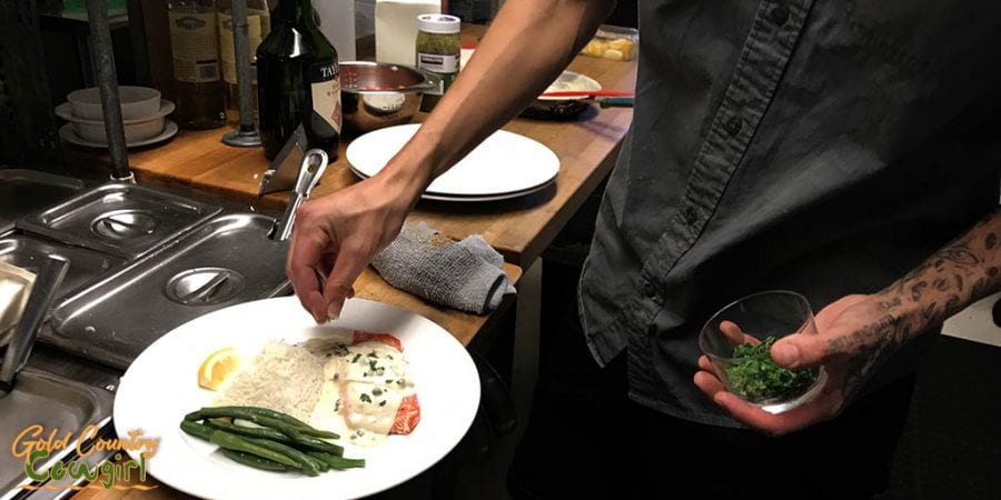 Putting the finishing touches on a plate of salmon