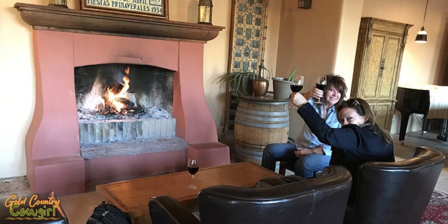 New friends Christy and Sue toasting in front of fireplace at Casa Rondeña Winery