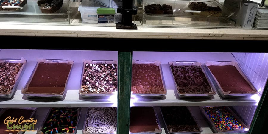 many pans of fudge in display case