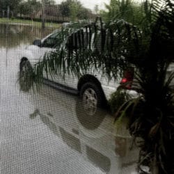 car parked in driveway in floodwater