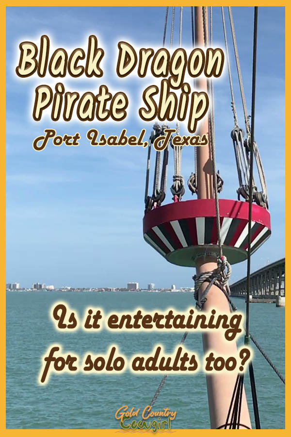 forward mast with South Padre Island in the background with text overlay: Black Dragon Pirate Ship Port Isabel, Texas Is it entertaining for solo adults too?