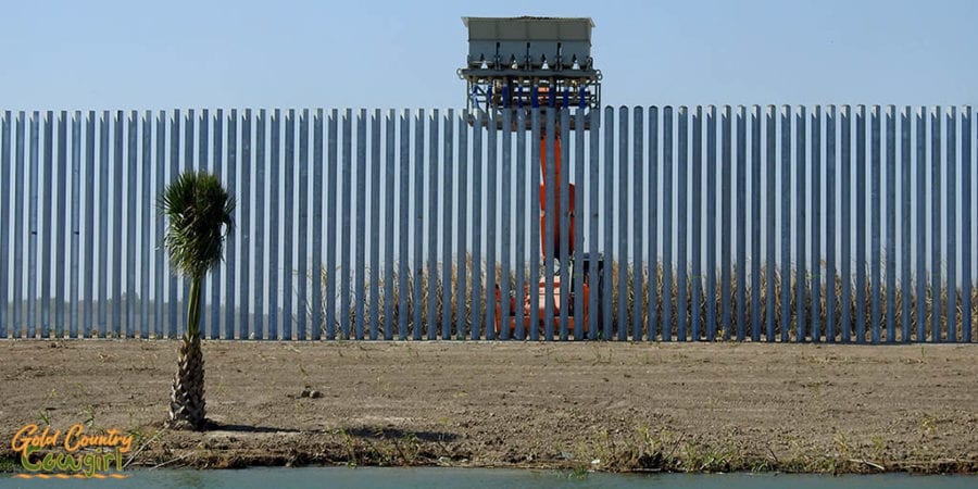 machine filling pipes of private border wall with gravel