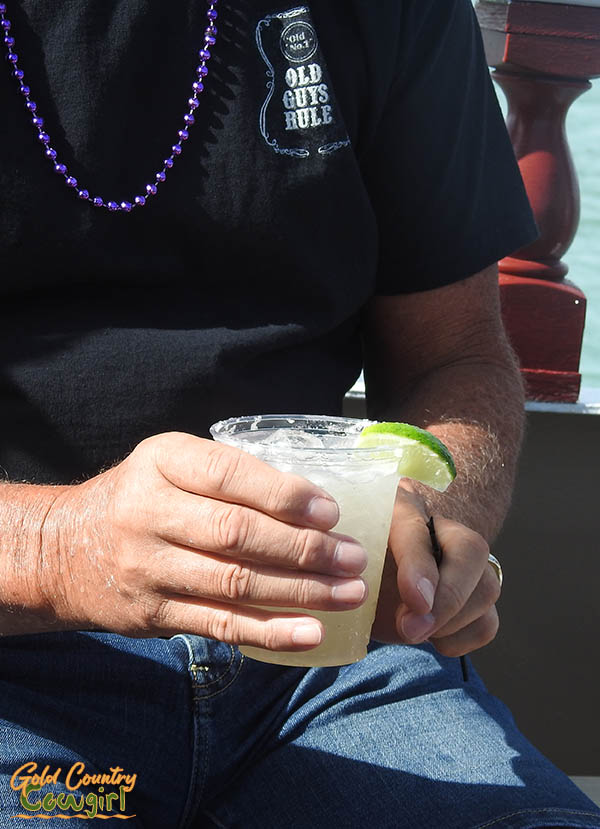 male hands holding a margarita