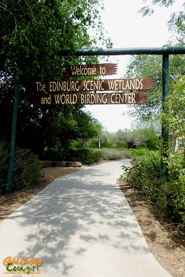 walkway with sign above Welcome to the Edinburg Scenic Wetlands and World Birding Center