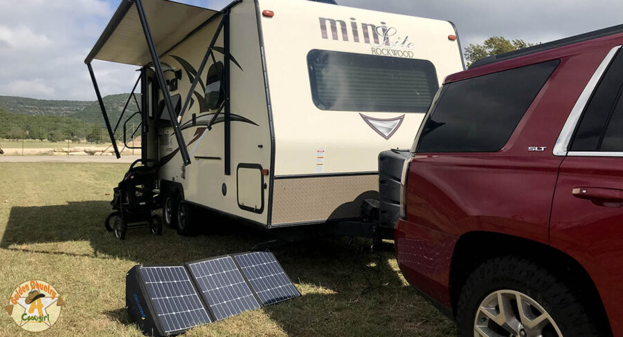 portable solar panels set up by travel trailer