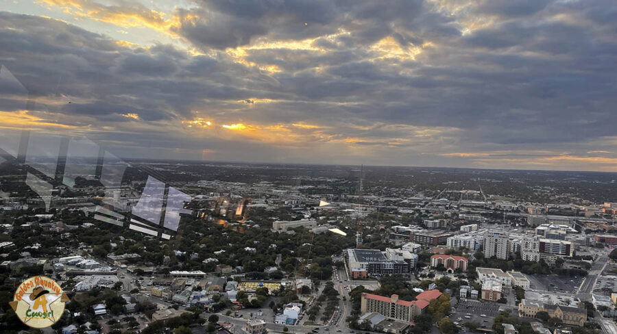 View of San Antonio from Tower of the Americas with the sun setting through clouds