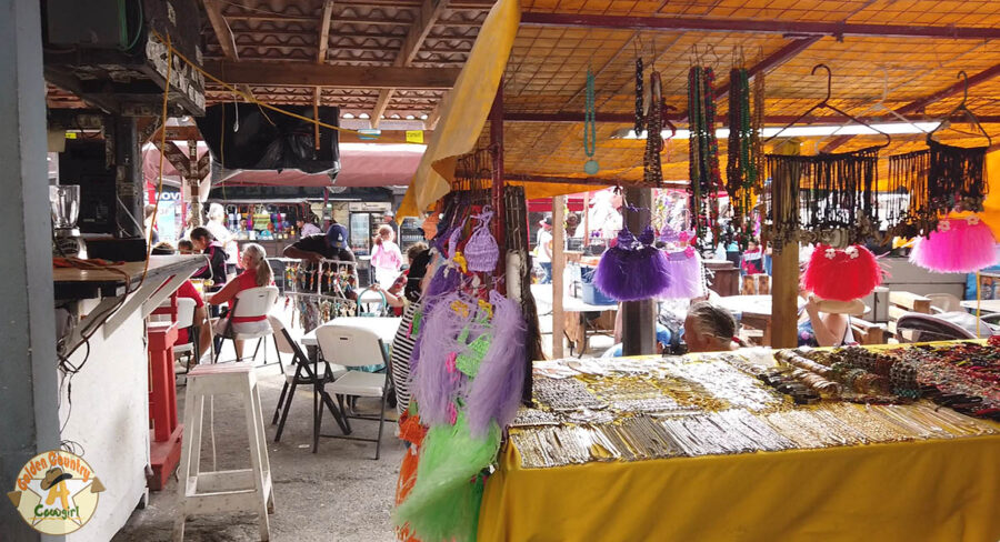 Looking through vendor stand to street scene on Tourist Day in Nuevo Progreso